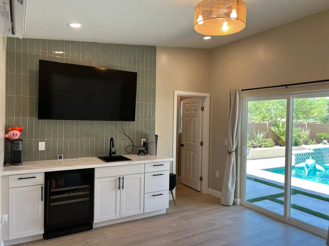 Kitchenette con azulejo verde, TV empotrada y frigobar